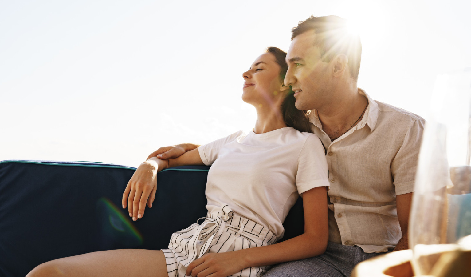 Happy couple in love on a yacht in summer on romantic vacation