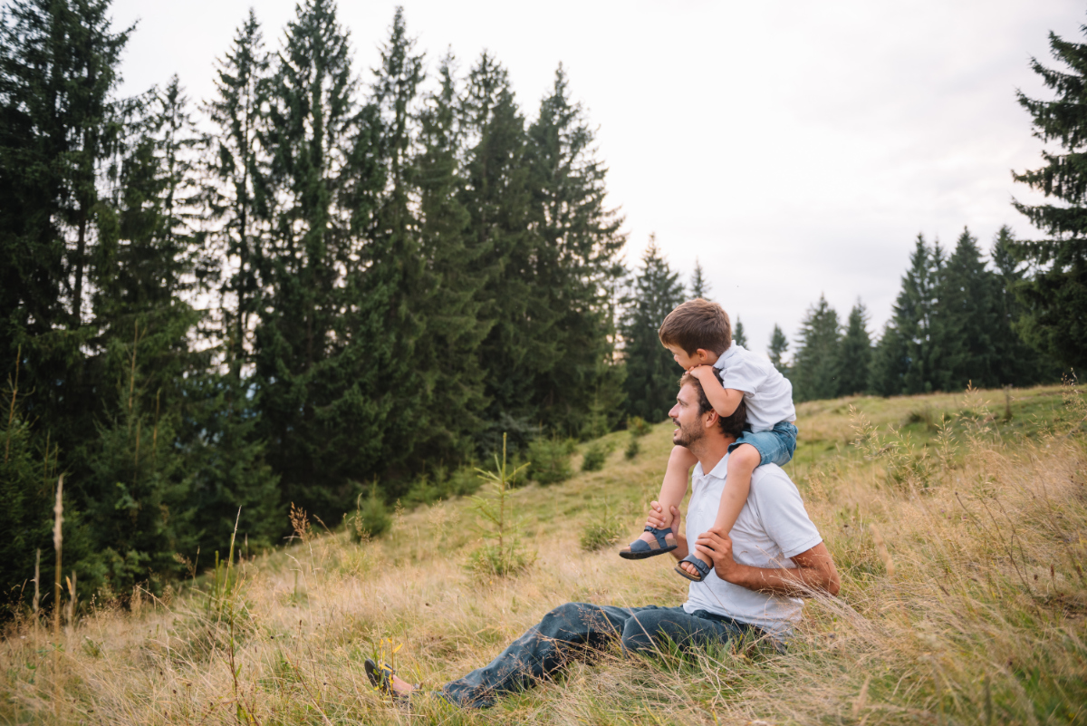 Happy father and little child are walking in the mountains. Father's Day. vacation in the national park.